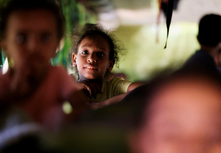 A girl sits in a bus as passengers fleeing from Sudan arrive at the Argeen land port, after being evacuated from Khartoum to Abu Simbel city, at the upper reaches of the Nile in Aswan