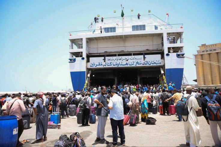 European, Asian and African nationals prepare to board a ship to Saudi Arabia, at Port Sudan