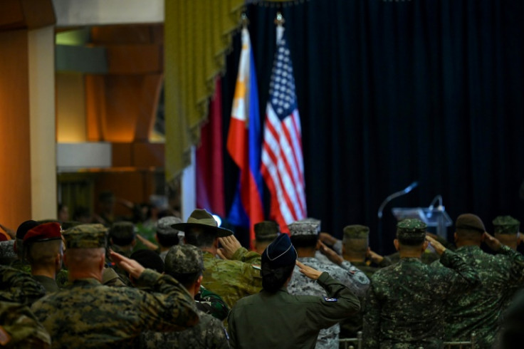 Soldiers salute on April 28, 2023 at Camp Aguinaldo in Quezon City during a closing ceremony for US-Philippine military exercises