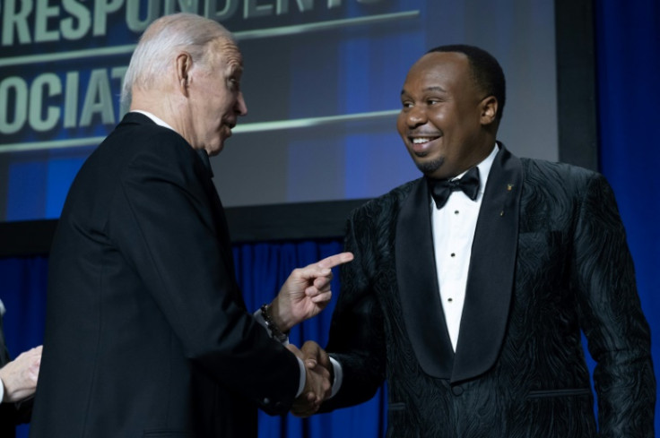 US comedian Roy Wood Jr (R) shakes hands with US President Joe Biden during the White House Correspondents' Association dinner