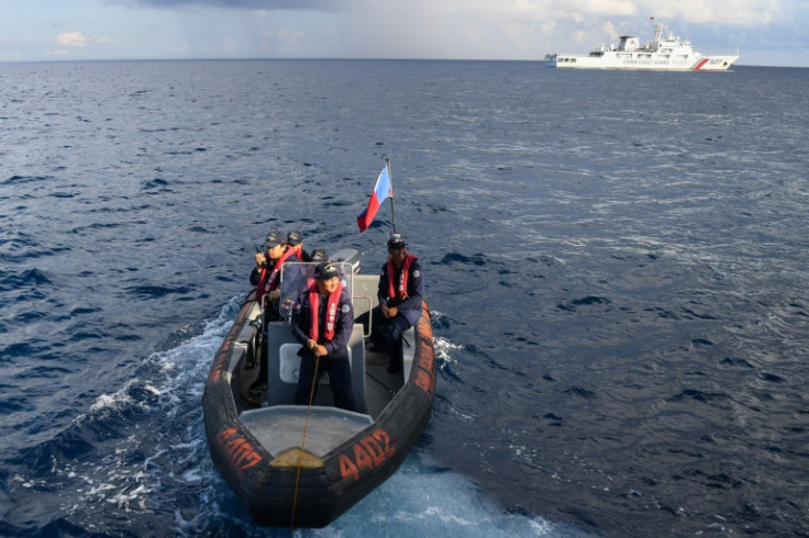 Personnel of a Philippine Coast Guard ship prepare to conduct a survey in the waters of Second Thomas Shoal in the disputed South China Sea on April 23, 2023