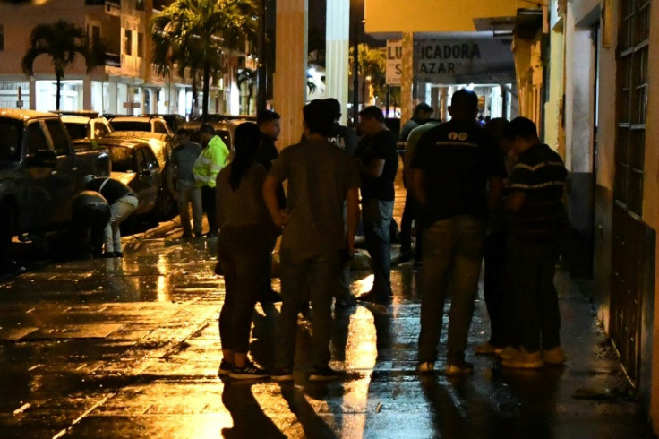 Ecuadorian police officers inspect a workshop after a murder rampage in Guayaquil, Ecuador on April 30, 2023