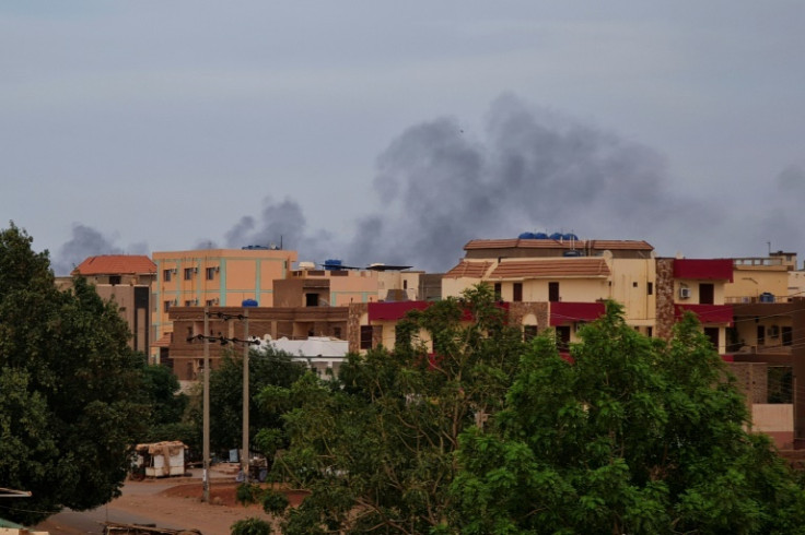 Smoke billows over residential buildings in Khartoum on April 30, 2023 as deadly clashes between rival generals' forces have entered their third week