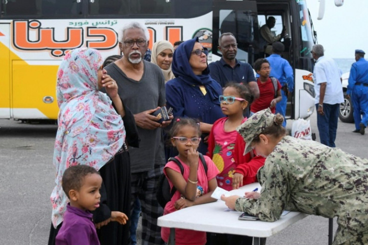 US military officers assist US nationals in boarding an evacuation vessel in Port Sudan amid ongoing deadly clashes between army forces and paramilitaries