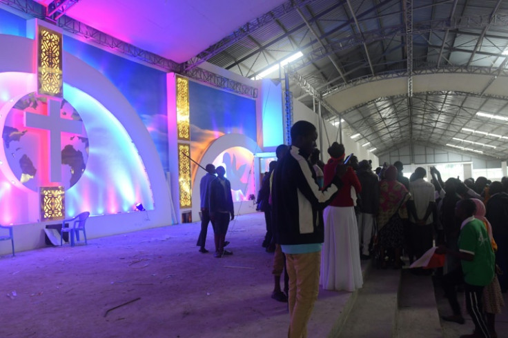 Business owners, shopkeepers and worshippers enter the New Life Prayer Centre in Mavueni on Sunday, during a protest against the closure of the church