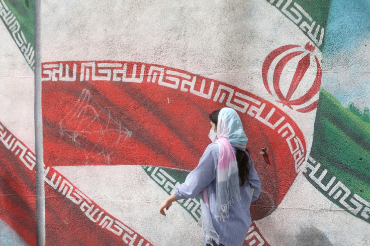 Iranian woman walks in a street in Tehran