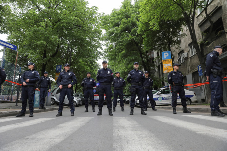 Police officers secure the area after a 14-year-old boy opened fire on other students and security guards at a school in downtown Belgrade