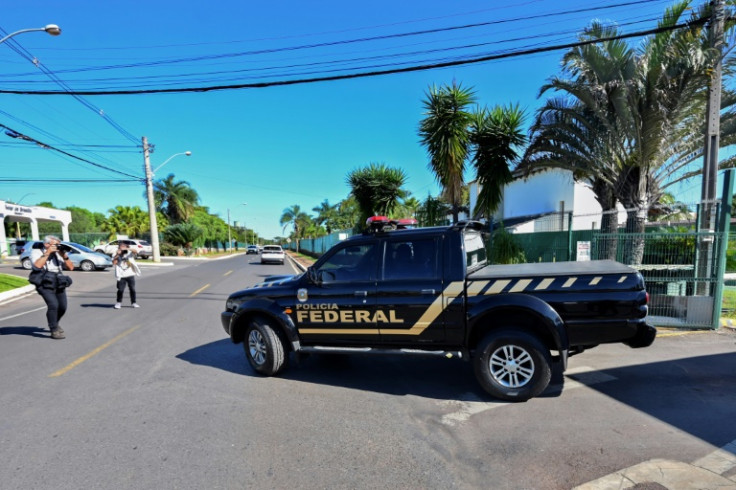 A Federal Police vehicle leaves the condominium where Brazilian ex-president Jair Bolsonaro lives, after searching his home as part of an investigation into allegations of falsifying Covid-19 vaccination certificates, in Brasilia on May 3, 2023