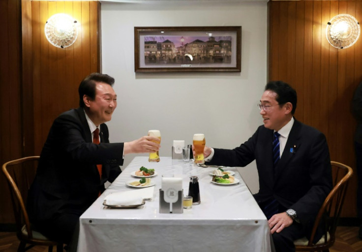 South Korea's President Yoon Suk Yeol (L) visited Tokyo in March and met with Japanese Prime Minister Fumio Kishida (R)
