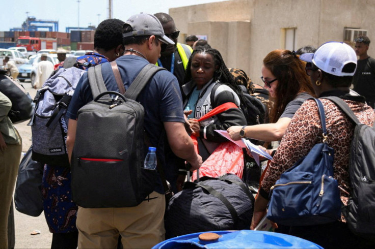 European, Asian and African nationals prepare to board a ship to Saudi Arabia, at Port Sudan