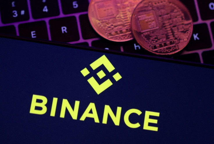 Illustration shows Binance logo and representation of cryptocurrencies
