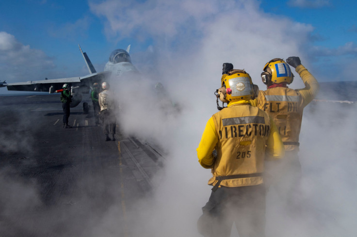 An E/A-18G Growler is directed on the flight deck of the U.S. Navy aircraft carrier USS Nimitz