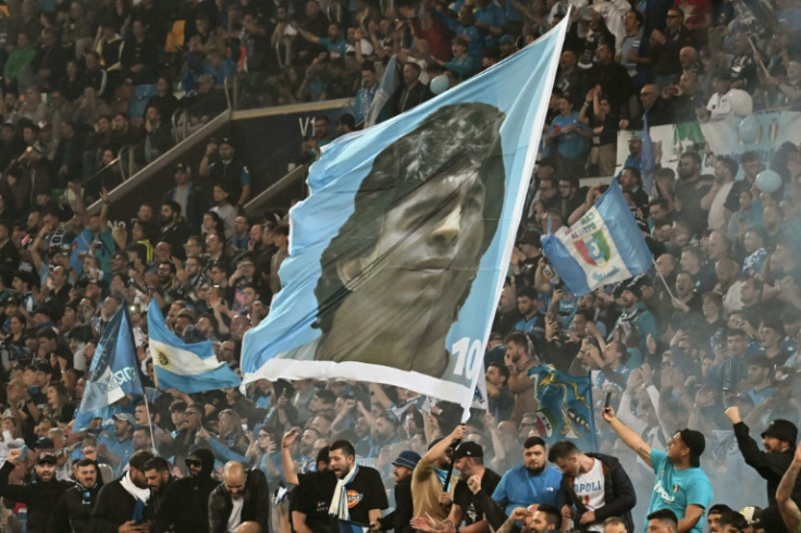 Napoli fans waving a giant flag of Diego Maradona, who led the club to their first two titles