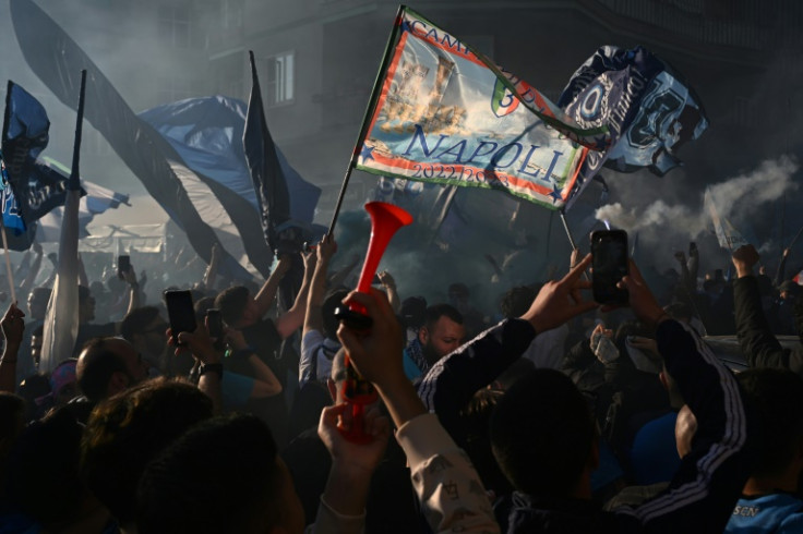 Napoli fans watching their side clinch a third 'Scudetto' on a giant screen at Maradona Stadium