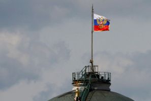 The Russian flag flies on the dome of the Kremlin Senate building in Moscow