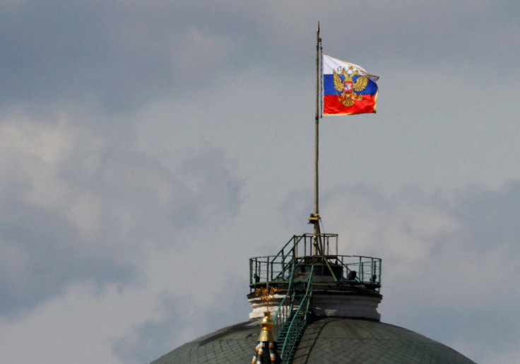 The Russian flag flies on the dome of the Kremlin Senate building in Moscow