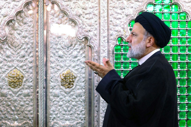 Iranian President Ebrahim Raisi prays at the holy shrine of Sayyida Zaynab in the southern suburbs of Damascus during two-day visit to Syria