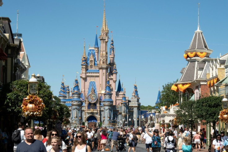 Visitors walk along Main Street at The Magic Kingdom at Walt Disney World, which is embroiled in a feud with Florida Governor Ron DeSantis