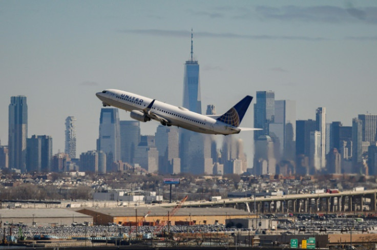 The New York City skyline is seen past a United Airlines aircraft during takeoff at Newark Liberty International Airport in Newark, New Jersey
