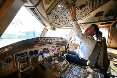 Pilot Omar Morsi checks controls in the cockpit of a United Airlines Boeing 777 aircraft at Newark Liberty International Airport in Newark, New Jersey