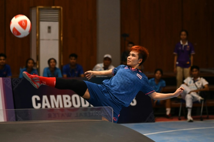 Thailand's Suphawadi Wongkhamchan in doubles action against one of two Cambodian sides in Phnom Penh