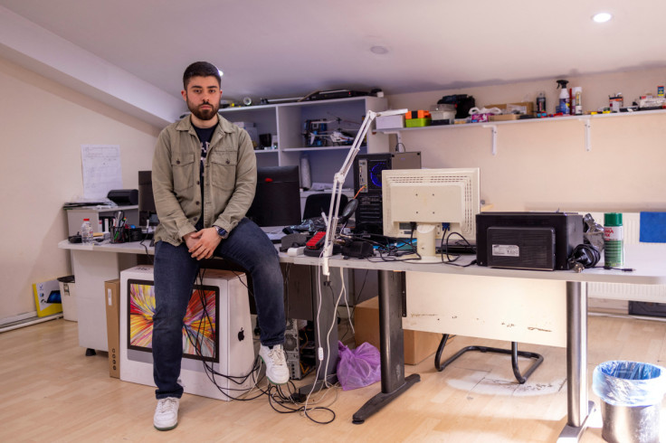 Emre Orgun, who works in the information technology department of a textile company, poses in his office in Istanbul