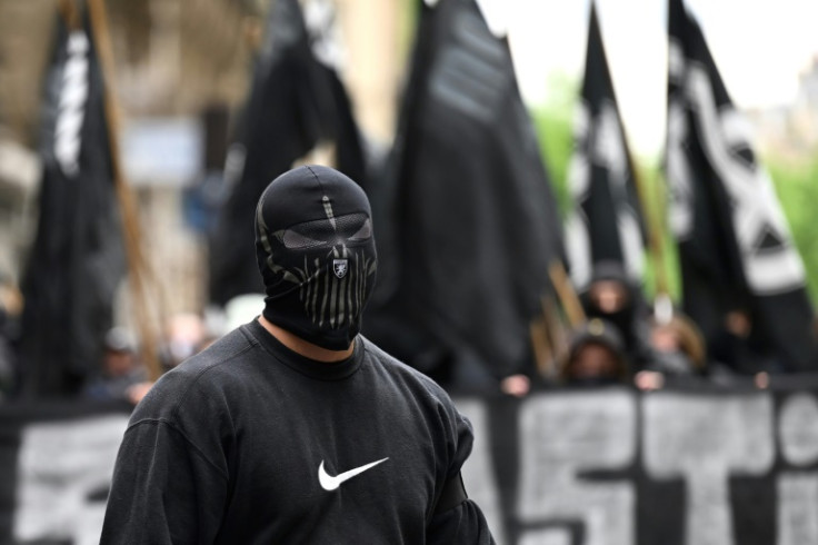 Some masked men acting as security guards were an intimidating presence at the demonstration