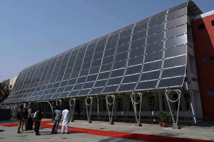 Students look at the facade of a building made with solar panels during its inauguration at the University of Engineering and Technology in Lahore in October 2020