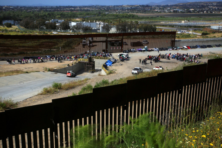 Hundreds of migrants amass near US-Mexico wall with COVID ban set to end