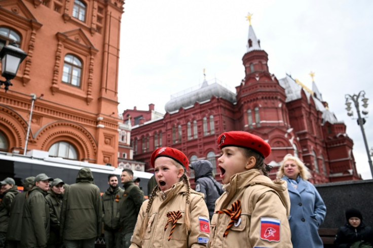 Children sing a patriotic song on the Manezhnaya Square in Moscow