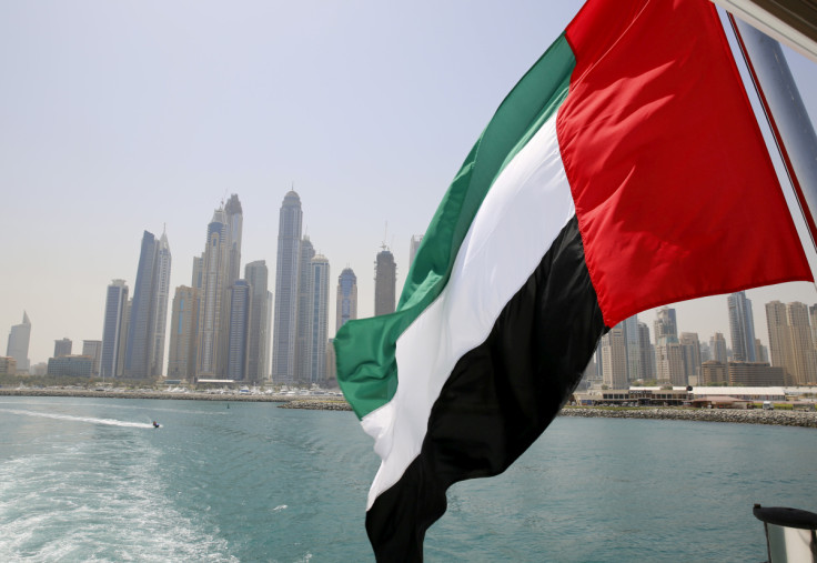 UAE flag flies over a boat at Dubai Marina