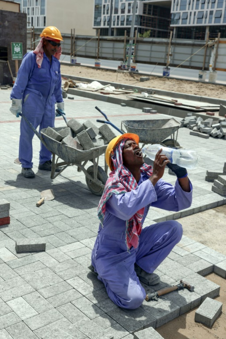 Foreign workers toil at a construction site in the Omani capital Muscat