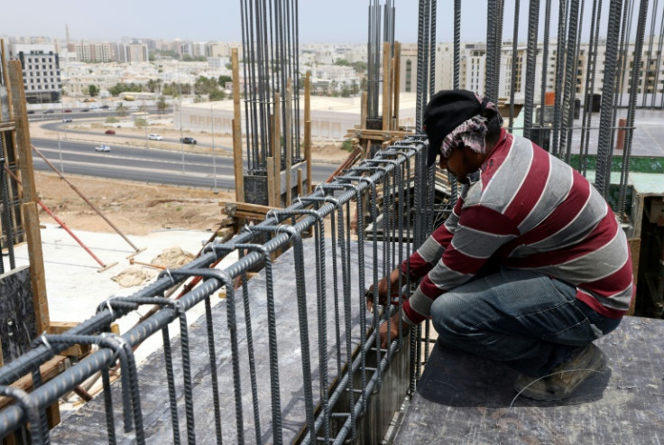 A foreign labourer toils in the heat on a construction site in the Omani capital Muscat