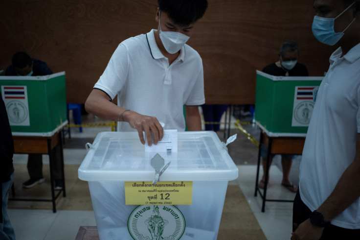 A man casts his early vote for the upcoming Thai general election at a polling station in Bangkok