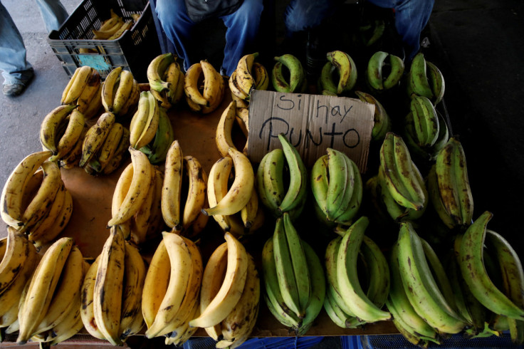 A sign that reads "There is a point" referring to the availability of a point-of-sale (POS), is seen in a bananas street vendor stall in Caracas