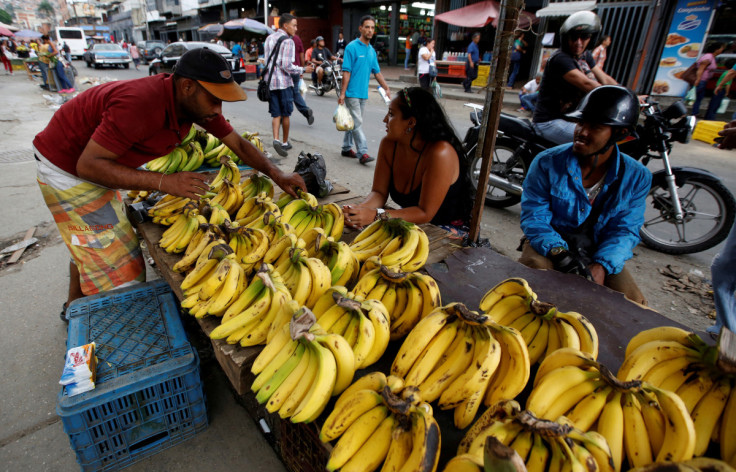Vendors sell bananas at a market in Caracas