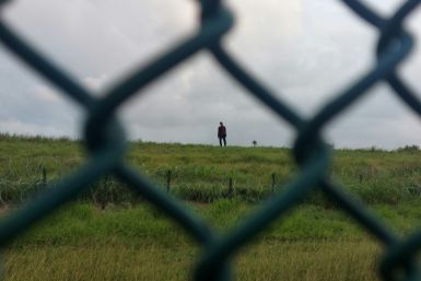 Jimmy Munoz, 29, of Ecuador, walks toward a checkpoint after turning himself in to the US Border Patrol in Brownsville, Texas, on May 9, 2023.