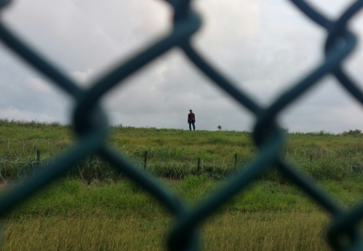Jimmy Munoz, 29, of Ecuador, walks toward a checkpoint after turning himself in to the US Border Patrol in Brownsville, Texas, on May 9, 2023.
