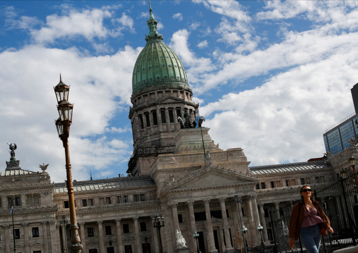 A pedestrian walks in front of the National Congress, as Argentines struggle amid rising inflation, in Buenos Aires,