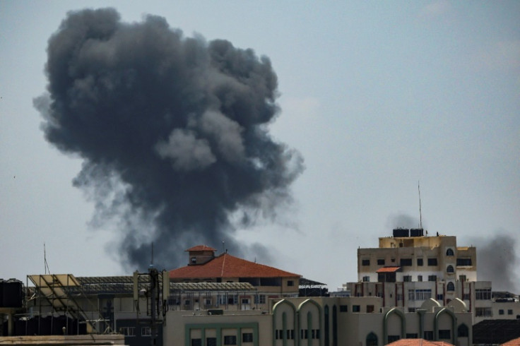 Smoke rises above buildings in Gaza City after during an Israeli air strike on May 13