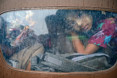 A girl looks out from a tuk-tuk while evacuating from Sittwe in Myanmar's Rakhine state