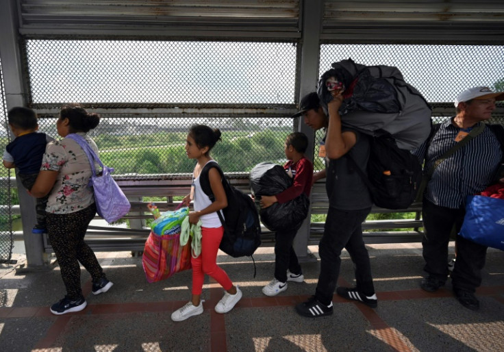 Migrants cross the US border from Matamoros in Mexico after obtaining an appointment to legally enter the United States
