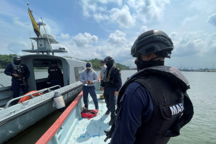 Ecuadoran naval police check the documents of the crew of a small boat intercepted near the port of Guayaquil on May 11, 2023