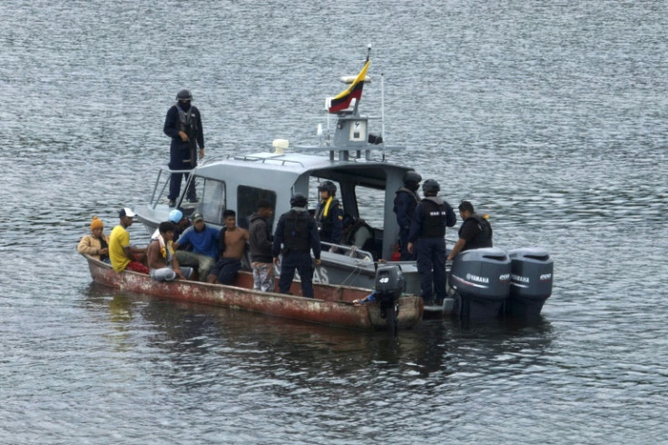 An Ecuadoran navy team checks documents on a small craft near Guayaquil on May 11, 2023