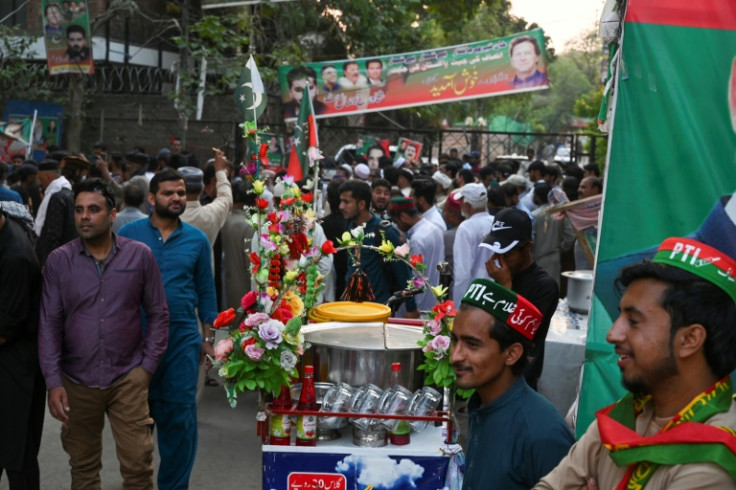 Tehreek-e-Insaf (PTI) party supporters gather outside Pakistan's former Prime Minister Imran Khan's residence to listen his speech, in Lahore on May 13, 2023