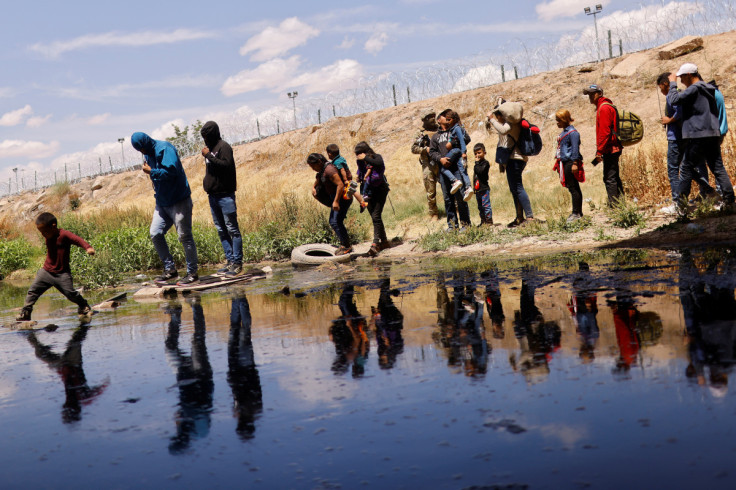 Migrants seeking asylum cross the Rio Bravo river to return to Mexico from the United States, as seen from Ciudad Juarez