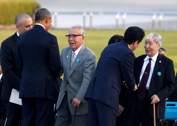 U.S. President Barack Obama and Japanese Prime Minister Shinzo Abe talk with atomic bomb survivors Shigeaki Mori and Sunao Tsuboi during their visit at Hiroshima Peace Memorial Park in Hiroshima