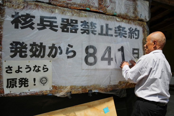 Atomic bomb survivor Toshiyuki Mimaki changes the numbers on a poster counting the days since the Nuclear Weapon Ban Treaty came into effect in Yamagata district