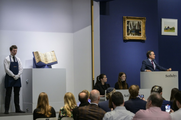 Sotheby’s auctioneer Benjamin Doller (R) takes bids during the Codex Sassoon sale at Sotheby’s in New York City on May 17, 2023