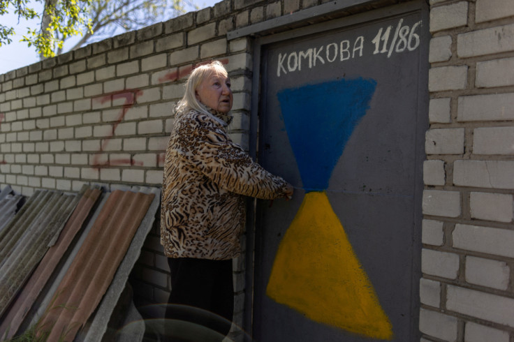 Valentyna Haras stands outside of her home in Kherson